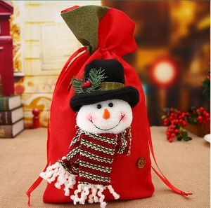 Detail of red burlap Christmas gift bag with a 3D snowman and drawstring closure