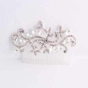 Close-up of floral alloy hair comb with crystals and pearls on white background