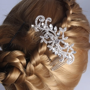 Detail view of silver floral hair comb with rhinestones styled on a braided hairstyle