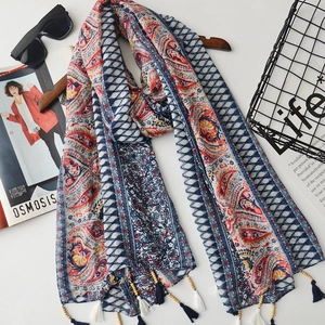 Detail of bohemian cotton linen scarf featuring colorful prints and wood bead tassels
