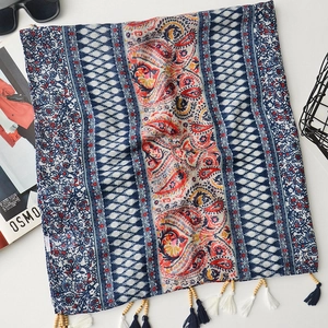 Detail of bohemian paisley shawl with handcrafted wood beads and tassel fringe trim