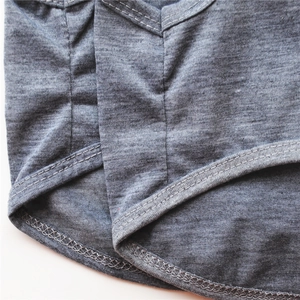 Detail of grey knitted pet vest showing double-stitched hem and fine fabric texture