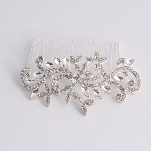 Close-up of silver hair comb with rhinestones and crystals in leaf and vine pattern