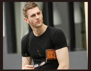 Close-up of man holding a vintage brown wallet with a hundred dollar bill pattern design