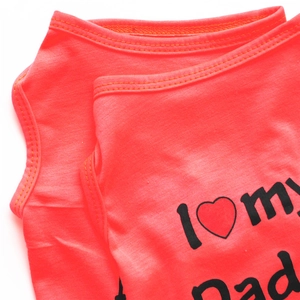 Detail of coral orange dog vest showing stitching and 'I Love my Dad' print