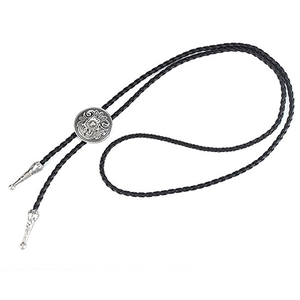 Close-up of Western cowboy bolo tie with Celtic floral silver buckle and black woven cord