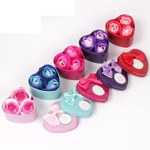 Detail of heart-shaped metal gift boxes with three scented soap roses in multiple colors