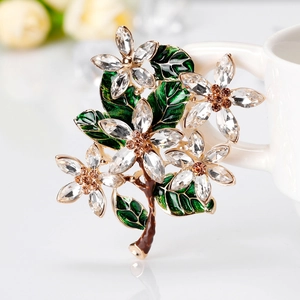 Elegant floral flower brooch with green enamel leaves and sparkling crystals in gold finish