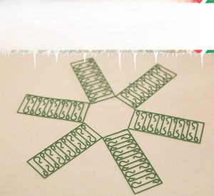 Detail of dark green S-shaped plastic hooks for Christmas tree ornament hanging