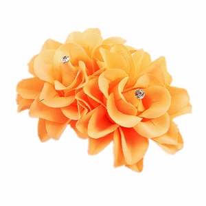 Detail of orange fabric double rose hair clip with sparkling rhinestone centers