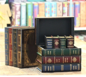Detailed view of an open vintage book-shaped wooden storage box set on a desk