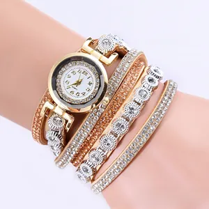 Detail view of multi-layer gold leather strap watch with sparkling crystal embellishments