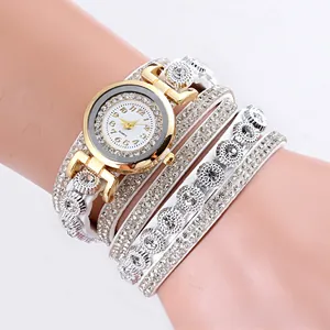 Detail of white multi-layer leather wrap watch with rhinestones and golden case