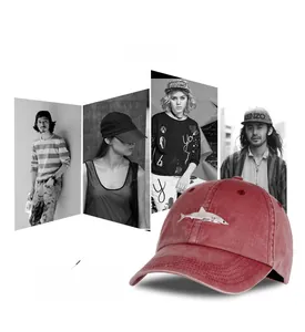 Close-up of vintage red washed cotton baseball cap with embroidered shark design