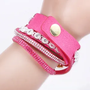 Detail of pink bohemian wrap bracelet with multiple rows of sparkling white rhinestones