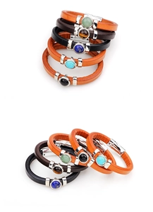 Detail of genuine leather bracelets with turquoise and tiger eye stones and magnetic clasps