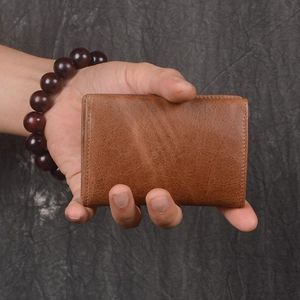 Handheld vintage brown genuine leather card wallet with compact folding design