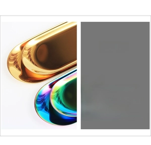 Detail of mirrored stainless steel oval tray showing gold and iridescent finish options