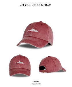 Detailed views of washed red cotton baseball cap with white shark embroidery detail