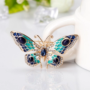 Elegant gold butterfly brooch with blue enamel wings and sparkling crystal rhinestones