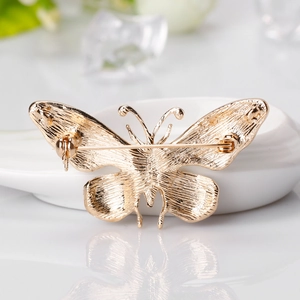 Golden butterfly brooch pin with elegant brushed metal texture and secure back clasp
