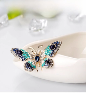 Detail of colorful butterfly brooch with blue enamel and sparkling crystals