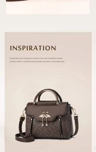 Detail of vintage brown monogram handbag featuring a gold double swan buckle and chain