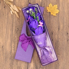Detail of purple soap rose bouquet with a cute bear in a premium matching gift box