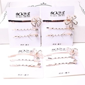 Close-up of four rose gold hair clip sets with floral and butterfly crystal designs