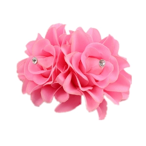 Pink fabric rose hair clip with dual chiffon flowers and central rhinestones on white base