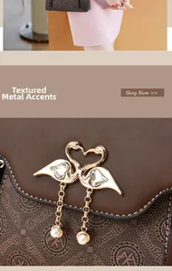Detailed close-up of swan heart hardware with pearls and crystals on brown handbag