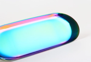 Close-up of a rainbow iridescent oval stainless steel tray with vibrant metallic luster