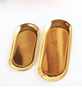 Macro view of gold stainless steel tray with mirror finish and smooth rounded edges