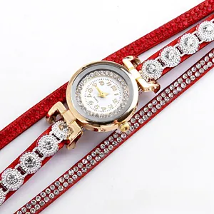 Macro shot of red leather multi-wrap watch featuring sparkling rhinestones and quartz movement