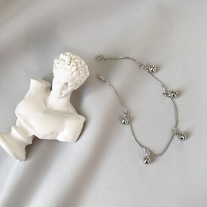 Minimalist S925 sterling silver beaded bracelet with round ball pendants on a white fabric