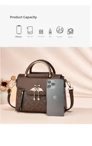 Detail view of vintage brown tote bag showing golden swan clasp and large storage capacity