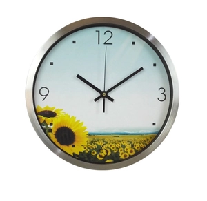 Detail of the brushed silver metal frame and sunflower dial of the silent wall clock