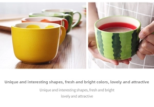 Close-up of ceramic fruit-themed mugs with watermelon and lemon patterns for kids