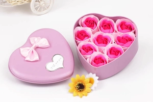Detailed view of purple heart metal box with pink soap roses and a silk bow