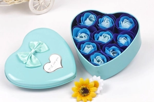 Detail of light blue heart-shaped metal box with 9 gradient blue soap roses and a bow