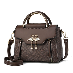 Vintage brown monogram handbag with swan clasp and golden ring handles for women