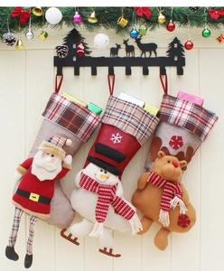 Close-up of three burlap Christmas stockings featuring 3D Santa, Snowman, and Reindeer characters