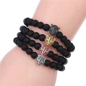 Detailed view of four beaded bracelets featuring leopard heads in multiple metallic finishes