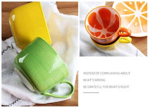 Detailed view of creative lemon and orange shaped ceramic mugs with matching fruit saucers