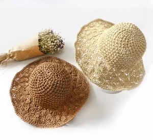 Detail of hand-crocheted sun hats with wavy brims and hollow weave in khaki and beige colors