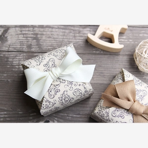 Close-up of vintage soap gift boxes with elegant patterns and silk ribbon bows