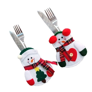 Detail of Christmas snowman cutlery holders showing soft felt fabric and festive embroidery