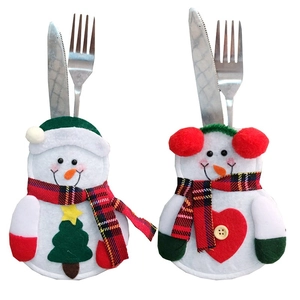 Close-up of felt snowman cutlery holders with festive green hat and red heart designs