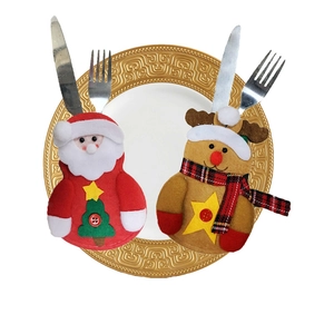 Christmas snowman and reindeer cutlery holders on a golden plate for holiday table decor