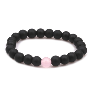 Detail of 8mm matte black stone and pink turquoise beads on a distance bracelet